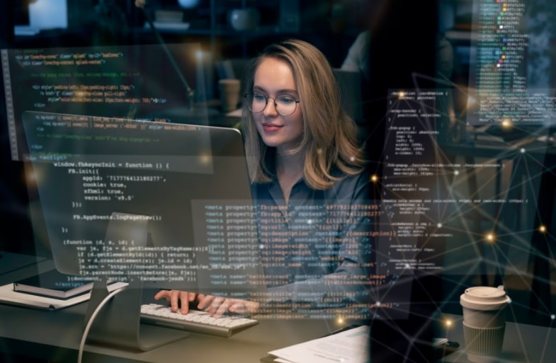 A person working on a computer with multiple displays