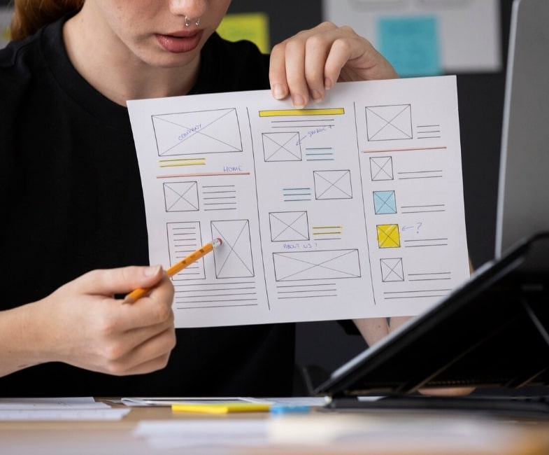 A person holding and pointing at a paper document