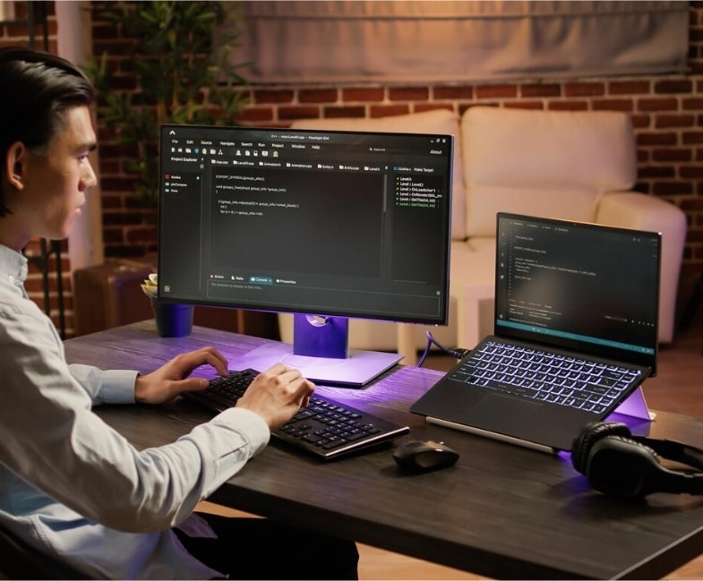 A person working on a computer with two displays