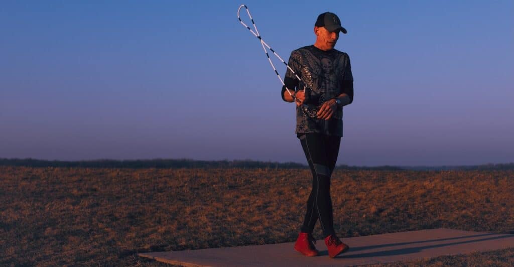 Dizzy Skips jumping rope at sunrise with red Fuego shoes on.